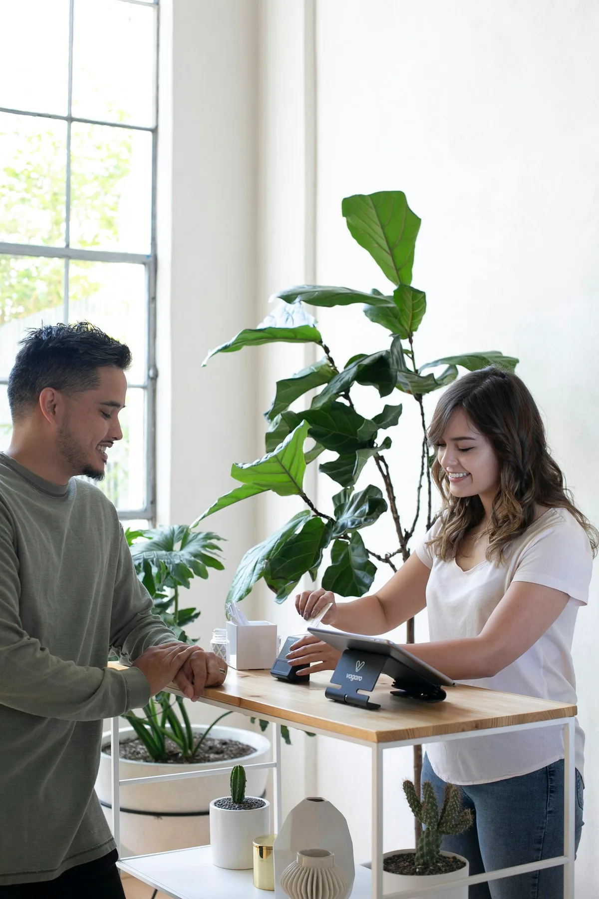An advisor and a client shaking hands across a desk