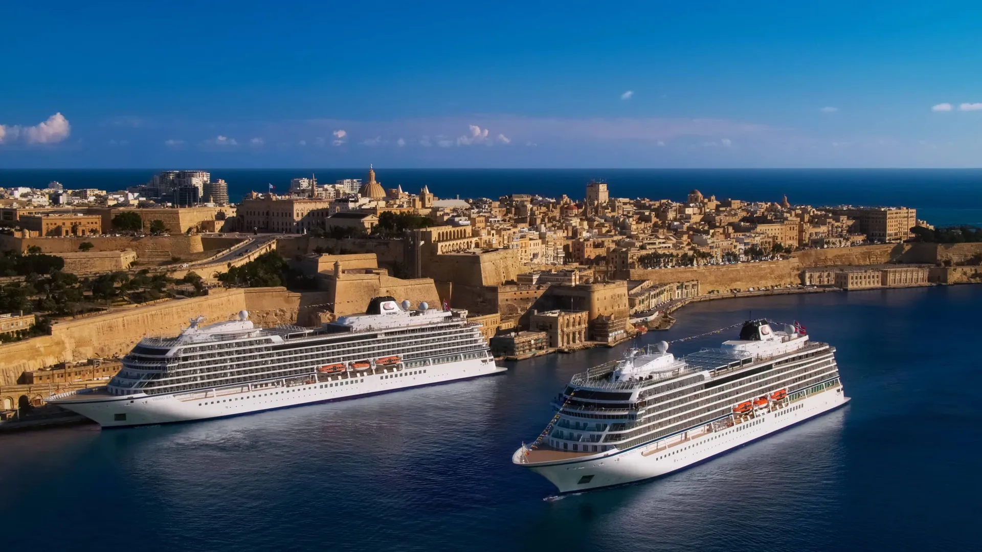 An ocean ship docked at a historic Mediterranean port