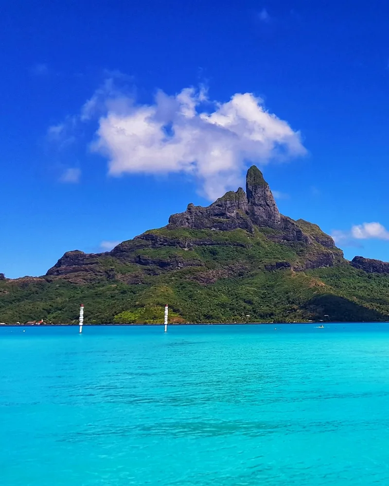 Overwater bungalows reaching into a Bora Bora lagoon