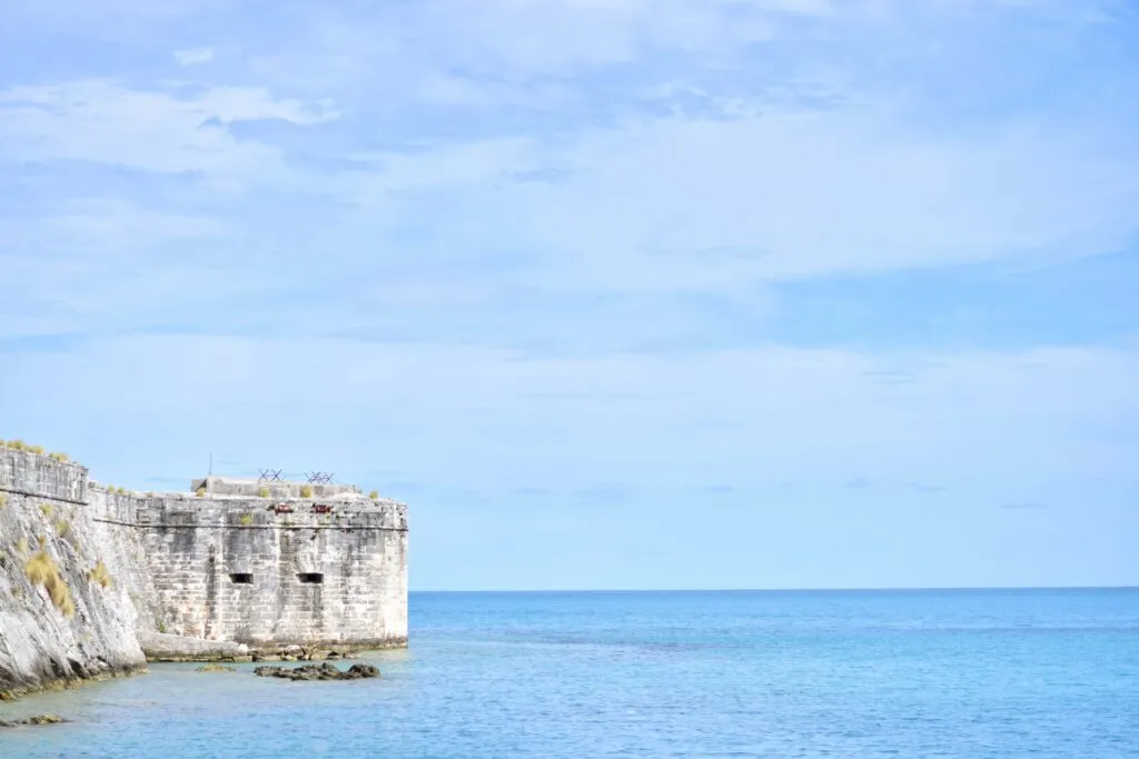 View of King's Wharf in Royal Naval Dockyard, Bermuda featuring a historic building on the left side.