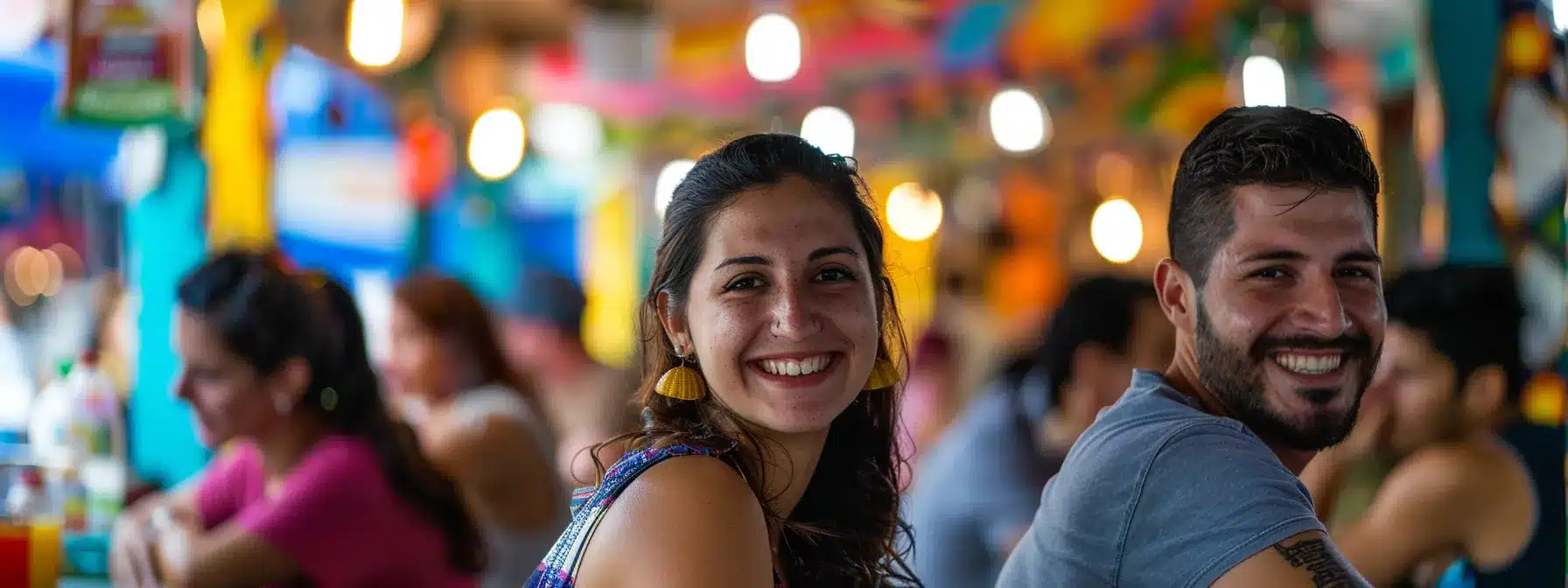 a smiling couple sitting at a colorful street food market in cleveland, enjoying a variety of budget-friendly and delicious dishes.