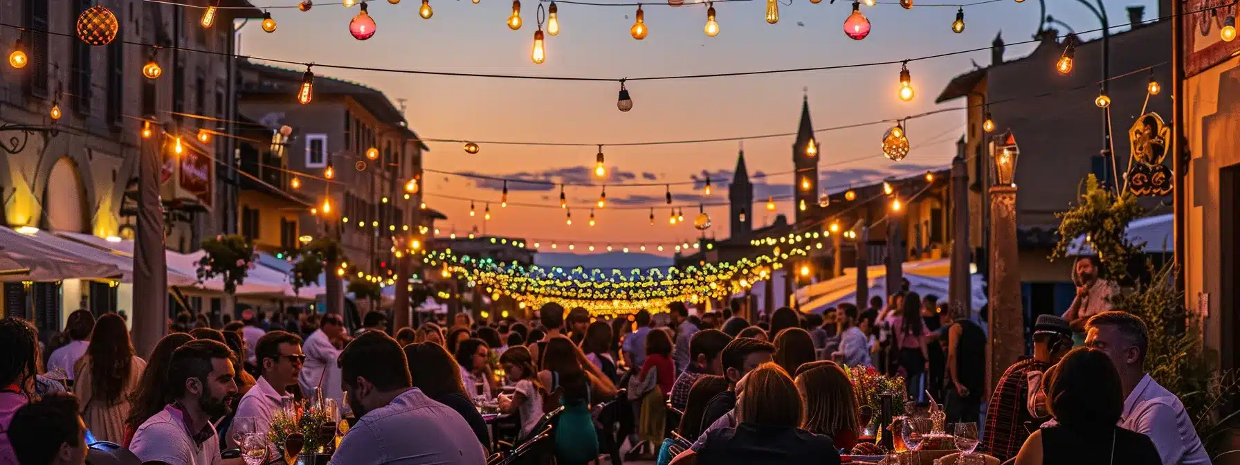 a lively alfresco dining festival in florence showcases an elegantly set long table adorned with vibrant summer dishes, surrounded by people enjoying communal meals under colorful string lights as the sun sets, evoking the festive spirit of tuscan summer flavors.