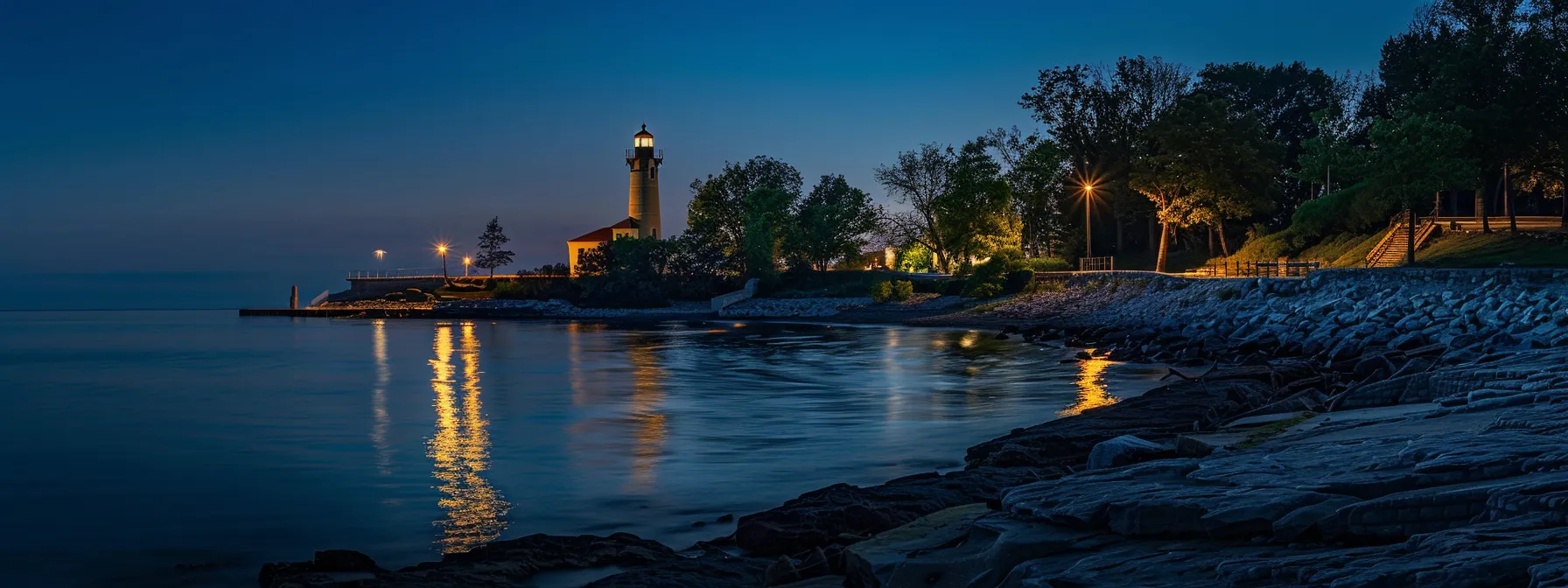a majestic historic lighthouse stands tall against the backdrop of lake erie's waterfront, symbolizing the region's rich maritime heritage.