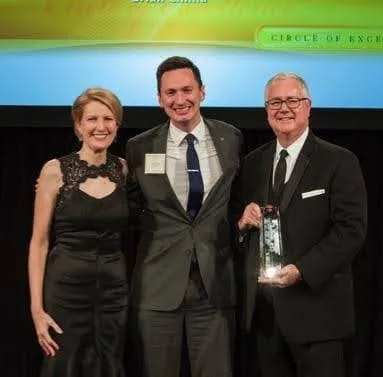 Brian Chima accepting an industry award on stage